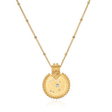 Mandala Zodiac Sagittarius Blue Topaz Necklace featuring a vibrant gold pendant, embodying spiritual jewelry that enhances meditation and serves as a talisman for protection and meaningful manifestation, ideal for yoga enthusiasts.
