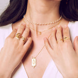 A display of layered jewelry including the Keeper of Positivity Eye Blue Topaz Ring, surrounded by other spiritual jewelry pieces that evoke protection and meaningful energy for meditation enthusiasts.