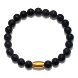 Enduring Faith Black Onyx Mens Stretch Bracelet featuring matte black onyx beads that symbolize endurance and perseverance, complemented by a gold gunmetal bead. Ideal as spiritual jewelry for meditation gifts, this meaningful and protective bracelet serves as a sacred amulet for yoga practice and manifestation.
