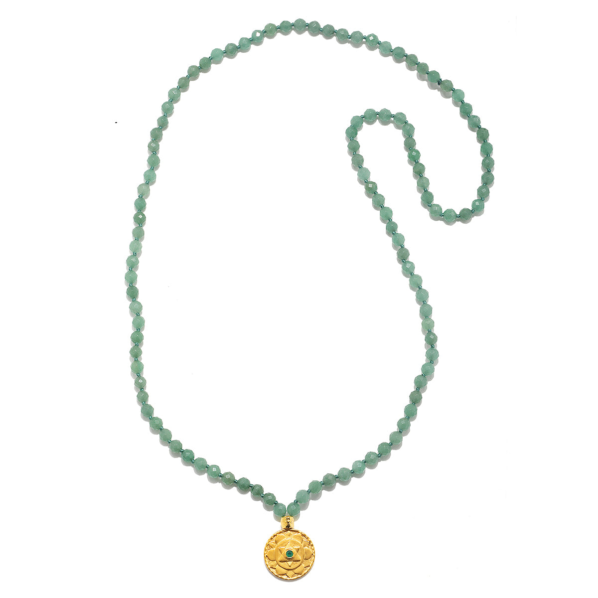 The Open to Love Chakra Mala is elegantly displayed, featuring a string of green aventurine beads and a gold pendant inscribed with the heart chakra symbol. A wonderful piece of spiritual jewelry, this mala embodies meanings of protection and love, perfect for meditation and yoga.