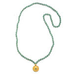 The Open to Love Chakra Mala is elegantly displayed, featuring a string of green aventurine beads and a gold pendant inscribed with the heart chakra symbol. A wonderful piece of spiritual jewelry, this mala embodies meanings of protection and love, perfect for meditation and yoga.