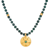 All Paths Malachite Mala Necklace featuring smooth malachite beads and a golden pendant with sacred symbols. This spiritual jewelry is ideal for meditation, serving as a talisman for protection and meaningful manifestation. Perfect for yoga enthusiasts, it embodies the essence of spiritual values and zodiac harmony.