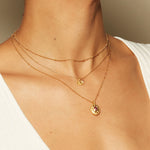 A stylish display of the Subtle Beauty Dot Chain Choker layered with various other necklaces, illustrating versatile spiritual jewelry options. This ensemble embodies the principles of protection, meditation, and meaningful expression.
