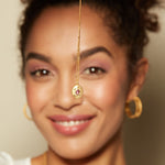 The Lotus Pink Tourmaline Birthstone Locket Necklace - October being held up by a smiling model, symbolizing spirituality and protection, perfect for yoga and meditation practices.