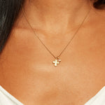 Model showcasing the Compassionate Faith Rose Quartz Cross Necklace, highlighting its elegant cross and rose quartz charm which serve as a talisman for protection, spirituality, and empowerment.