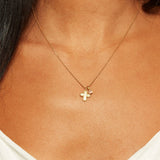 Model showcasing the Compassionate Faith Rose Quartz Cross Necklace, highlighting its elegant cross and rose quartz charm which serve as a talisman for protection, spirituality, and empowerment.