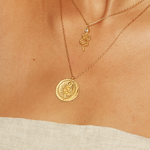 Eternal Energy Snake Coin Necklace layered with another delicate gold necklace, showcasing the serpent pendant's shine. Ideal for those seeking talismans for yoga, manifestation, and spiritual meaning in their daily lives.