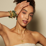 Close-up of a model wearing the Enduring Individuality White Topaz Snake Necklace paired with vibrant bracelets, representing a blend of beauty and spirituality, making it a perfect charm for zodiac enthusiasts and yoga practitioners.