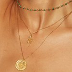 Stylish layered necklaces featuring the Enduring Individuality White Topaz Snake Necklace alongside other pieces, embodying spiritual meaning and elegance, ideal for manifestation and as a talisman during meditation.