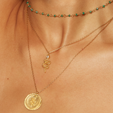 Stylish layered necklaces featuring the Enduring Individuality White Topaz Snake Necklace alongside other pieces, embodying spiritual meaning and elegance, ideal for manifestation and as a talisman during meditation.
