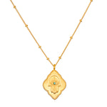 Cradled in Protection Gold Hamsa Necklace, an intricately designed spiritual jewelry piece symbolizing protection and blessings. This talisman features a hamsa hand with an evil eye and emerald gemstone, making it a meaningful charm for meditation and manifestation in your yoga practice. Perfect for those who resonate with zodiac energies, this necklace embodies the essence of sun and moon, enhancing your spiritual journey.