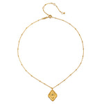 An elegant display of the Cradled in Protection Gold Hamsa Necklace on a plain background, emphasizing its craftsmanship and the themes of spirituality, protection, and yoga, making it a perfect talisman for manifestation and charm.