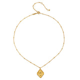 An elegant display of the Cradled in Protection Gold Hamsa Necklace on a plain background, emphasizing its craftsmanship and the themes of spirituality, protection, and yoga, making it a perfect talisman for manifestation and charm.
