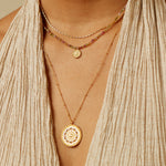 Model wearing the Inner Light Mandala Necklace layered with other necklaces, showcasing its charm and significance in spiritual practices such as meditation and zodiac rituals, contributing to a beautiful and meaningful look.