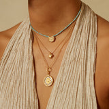 Layered necklaces featuring the Inward Journey Pearl Mandala Necklace alongside other delicate pieces, embodying the essence of spiritual jewelry and charm, designed for meditation and connection to zodiac energies. A perfect combination for yoga enthusiasts and those seeking meaningful adornments.