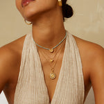 A model wearing the Enlightened Journey Mandala Lotus Charm Necklace layered with other necklaces, showcasing a stylish spiritual look ideal for yoga, meditation, and charm collections.