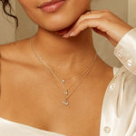 A model showcasing the Incandescent Spirit 14kt Gold Diamond Necklace layered with other delicate gold necklaces, embodying spiritual elegance, perfect for zodiac lovers and meditation practices, emphasizing the charm and meaning behind spiritual jewelry.