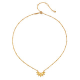 Close-up view of the Emergence Gold Sunburst Necklace featuring a delicate sunburst pendant, a stunning piece that embodies the meaning of the sun in zodiac spirituality and serves as a lovely charm for yoga and meditation.