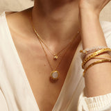 The Drift Into Daydreams Moonstone Gemstone Necklace displayed alongside other jewelry, emphasizing its role as a talisman for protection and manifestation in daily life.