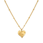 Spirit of Love Gold Heart Necklace featuring a delicate 18k gold plated heart pendant with elegant scrollwork, perfect for wearing during meditation or as a talisman for spiritual meaning and manifestation.