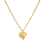 Spirit of Love Gold Heart Necklace featuring a delicate 18k gold plated heart pendant with elegant scrollwork, perfect for wearing during meditation or as a talisman for spiritual meaning and manifestation.
