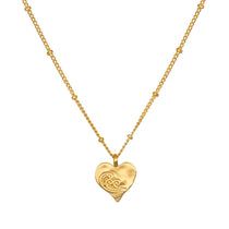 Spirit of Love Gold Heart Necklace featuring a delicate 18k gold plated heart pendant with elegant scrollwork, perfect for wearing during meditation or as a talisman for spiritual meaning and manifestation.