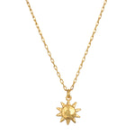 Here Comes the Sun Necklace featuring a hammered 18kt gold plated sun pendant on a delicate chain, embodying the meaning of vitality and leadership. This spiritual jewelry is perfect for meditation and manifestation, resonating with the sun's powerful energy. Ideal for yoga enthusiasts seeking meaningful talismans.