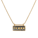Self Evolution Moon Phase Necklace showcasing the beautiful moon phases on a gold-plated bar against a gunmetal background, perfect for spiritual jewelry and meditation, symbolizing protection and manifestation.