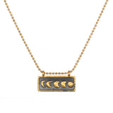 Self Evolution Moon Phase Necklace showcasing the beautiful moon phases on a gold-plated bar against a gunmetal background, perfect for spiritual jewelry and meditation, symbolizing protection and manifestation.