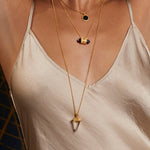 Truthful Guidance Crystal Pendulum Necklace worn layered with other necklaces, showcasing its elegant design. This spiritual jewelry piece enhances meditation practices and embodies the meaning of protection and meaningful talisman for yoga enthusiasts.