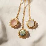 Display of three beautiful necklaces including the Unlimited Compassion Rose Quartz Gemstone Necklace, showcasing different gemstone pendants, ideal for spiritual practices, symbolizing protection and spiritual energy while enhancing your meditation experience.