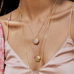 Ganesha Hindu God, Loving Harmony Necklace elegantly layered with other gold necklaces, showing the Ganesha pendant alongside rose quartz, representing the perfect meditation gifts. This symbolic and sacred jewelry enhances the wearer’s spiritual journey, ideal for invoking meaning and practice in yoga and mantra.
