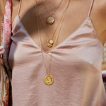Ganesha Hindu God, Loving Harmony Necklace beautifully displayed on a model, showcasing its details and significance as a spiritual jewelry piece. This necklace, enriched with cherry quartz, serves as a protective amulet and supports meaningful manifestation during yoga and meditation practices.