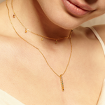 Woman wearing the Divine Alignment Gemstone Chakra Necklace, featuring colorful gemstones representing the seven chakras, perfect for spiritual jewelry and meditation gifts, symbolizing balance and harmony in yoga and manifestation.