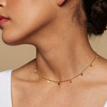 Model wearing the Moon Phases of Femininity Gold Choker, emphasizing its elegance and spiritual significance. This meaningful choker serves as a beautiful amulet in meditation practices, blending seamlessly into a yoga-inspired lifestyle with its protective and sacred qualities.