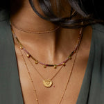 Model wearing the Peace & Protection Tourmaline Choker layered with other delicate necklaces, showcasing spiritual jewelry that embodies protection, sacred meaning, and a vibrant energy ideal for manifestation and zodiac inspirations.