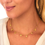 Model wearing the Aligned in Harmony Chakra Choker, emphasizing its radiant gold design and chakra symbols. This spiritual jewelry piece serves as a meaningful talisman for manifestation, connecting the sun, moon, and zodiac energies during meditation and yoga.