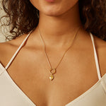 Model wearing the Deeply Rooted Tree Charm on a delicate chain, showcasing how this spiritual jewelry piece adds a touch of elegance and meaning. Ideal for meditation and as a talisman, it represents grounding and protection, harmonizing beautifully with sun and moon energies.