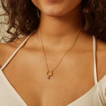 Amethyst Bezel Charm elegantly displayed on a gold necklace, symbolizing spirituality and the moon, making it a perfect talisman for yoga practice and meditation, enhancing your meaningful charm collection.
