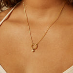 Citrine Bezel Charm displayed on a person, showcasing the spiritual jewelry's radiant glow. Ideal for meditation and as a talisman for protection and meaningful manifestation, this charm complements a yoga practice and embodies the essence of sun and moon energy.