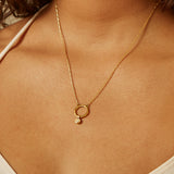 Citrine Bezel Charm displayed on a person, showcasing the spiritual jewelry's radiant glow. Ideal for meditation and as a talisman for protection and meaningful manifestation, this charm complements a yoga practice and embodies the essence of sun and moon energy.