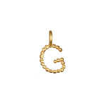 Charming Initial Letter 'G' fashioned in 18kt gold plate, perfect for personalizing your jewelry layers. This charm signifies spiritual meaning, protection, and enhances your meditation practice, making it a beautiful addition to your spiritual adornments.