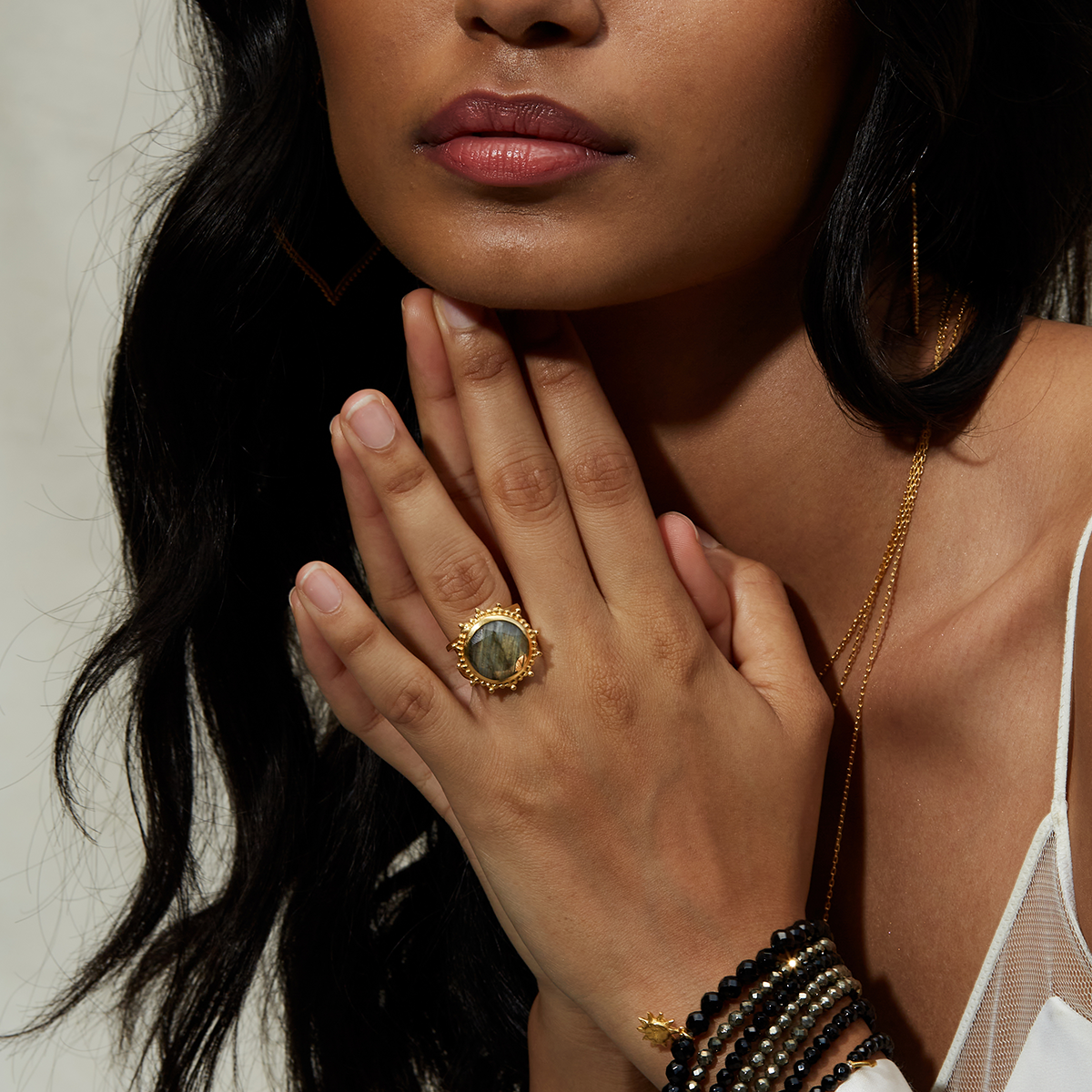 Close-up of a person wearing the Pursue Your Truth Labradorite Ring, showcasing its unique design with spiritual meaning for yoga, zodiac, and as a talisman for perseverance and imagination.