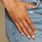 The Evolving Goddess Moonstone Ring elegantly displayed on a hand, reflecting its golden charm. This piece symbolizes meaningful connections to spirituality, protection, and lunar energies, perfect for yoga and meditation practices.