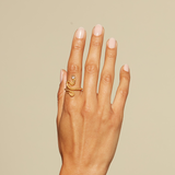A minimalist shot of a hand wearing the Beauty is Timeless Snake Adjustable Ring. This elegant piece is not just a charm but embodies values of spirituality and protection, making it a meaningful addition to any meditation or yoga practice.