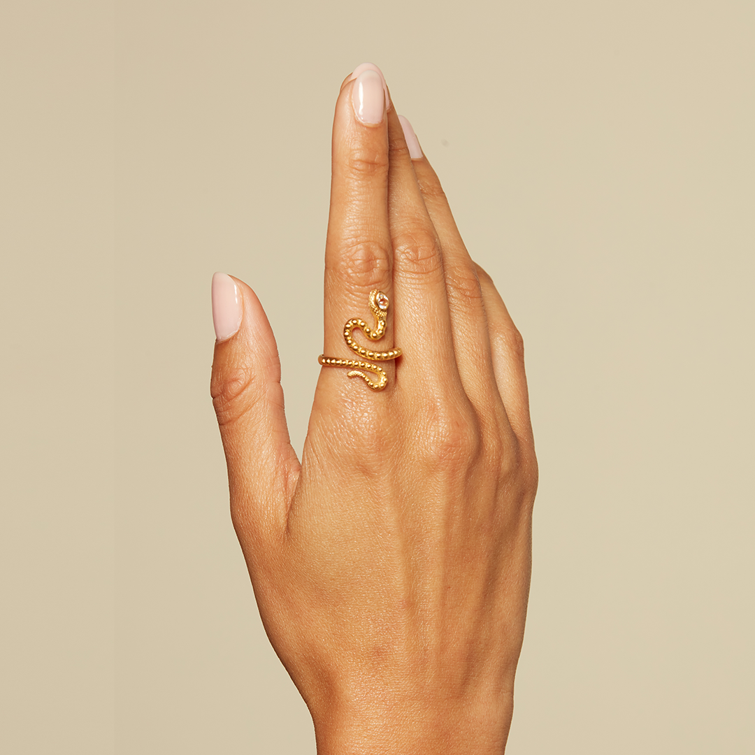A close-up view of a hand adorned with the Beauty is Timeless Snake Adjustable Ring, highlighting its unique design. This beautiful piece serves as a talisman, connecting the wearer to spiritual elements and enhancing their journey into self-understanding and manifestation.