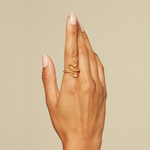 A close-up view of a hand adorned with the Beauty is Timeless Snake Adjustable Ring, highlighting its unique design. This beautiful piece serves as a talisman, connecting the wearer to spiritual elements and enhancing their journey into self-understanding and manifestation.