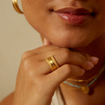 Loving Mantra Spinning Ring displayed near a person's face, emphasizing its significance in manifesting love, with elements of talismans and spiritual meaning.