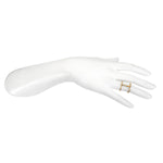 The Divine Alignment Chakra Adjustable Ring displayed on a white mannequin hand, emphasizing its adjustable design crafted from 18kt gold plate, making it a beautiful addition to yoga and mantra practices, offering protective and sacred energy.