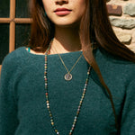 A model wearing the Leo Zodiac Necklace, showcasing its design as spiritual jewelry, perfect for meditation gifts. The necklace symbolizes the strength of the zodiac with protective qualities, making it a meaningful amulet for yoga and manifestation.